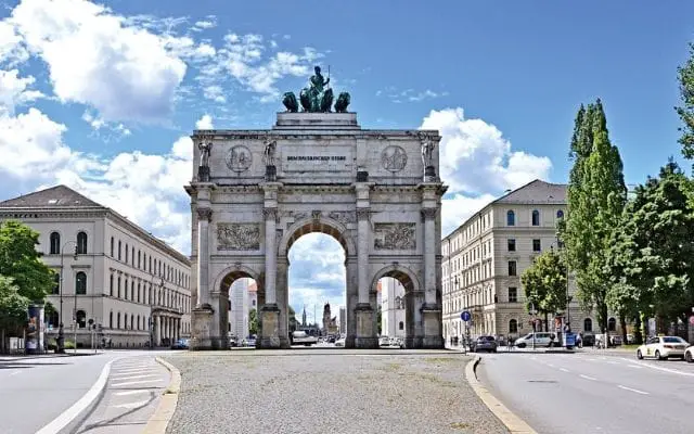 Siegestor Munich Victory Gate photo with blue white skies and white clouds behind