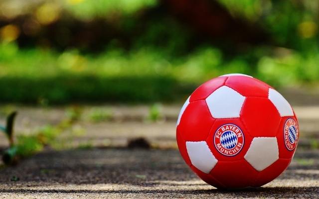 Red and White Football with the FC Bayern Munich logo are just one of the Football Teams in Munich