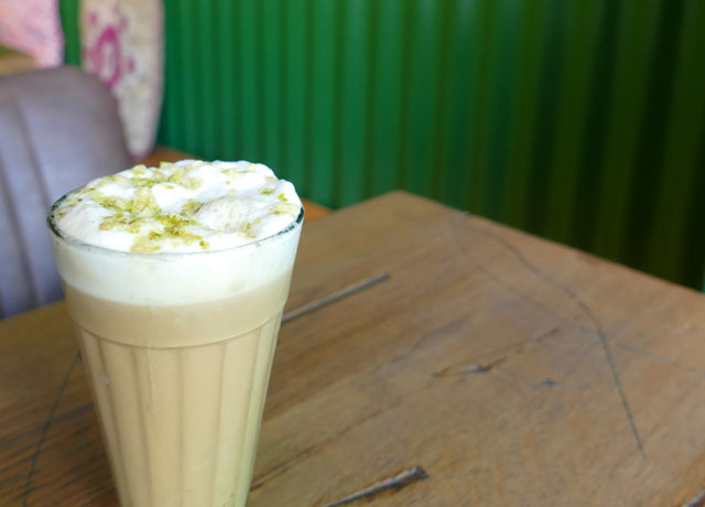 Badami Chai Tea, spiced with almonds, cardamom and sprinkled with pistachio at Bindaas, Munich