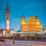 Is Augsburg Worth Visiting image showcasing the Town Hall and Perlach Tower in the evening