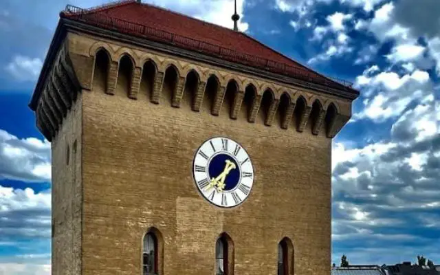 Isartor Munich city gate featuring the clock tower with blue skies behind