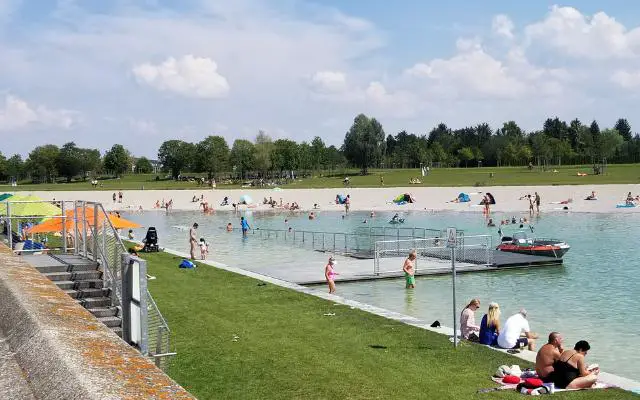 Riemer Park Munich in summer featuring people swimming in the Rimmersee.