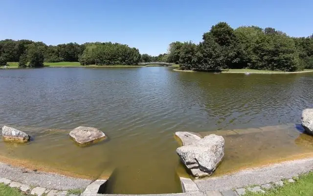 Ostpark Munich shot over lake from ground level towards bridge