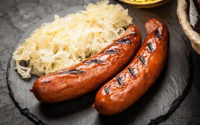 Sauerkraut Origin featuring grilled bratwurst with Sauerkraut side